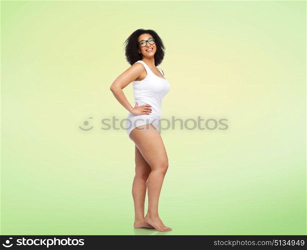body positive and people concept - happy african american woman in white underwear over lime green background. happy african american woman in white underwear. happy african american woman in white underwear