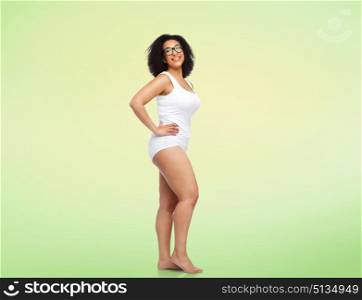 body positive and people concept - happy african american woman in white underwear over lime green background. happy african american woman in white underwear. happy african american woman in white underwear