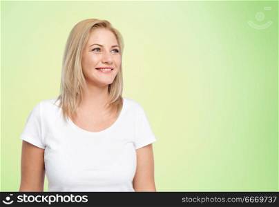 body positive and people concept - happy woman in white t-shirt over lime green natural background. happy woman in white t-shirt over lime green. happy woman in white t-shirt over lime green