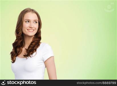 body positive and people concept - happy woman in white t-shirt over lime green natural background. happy woman in white t-shirt over lime green. happy woman in white t-shirt over lime green