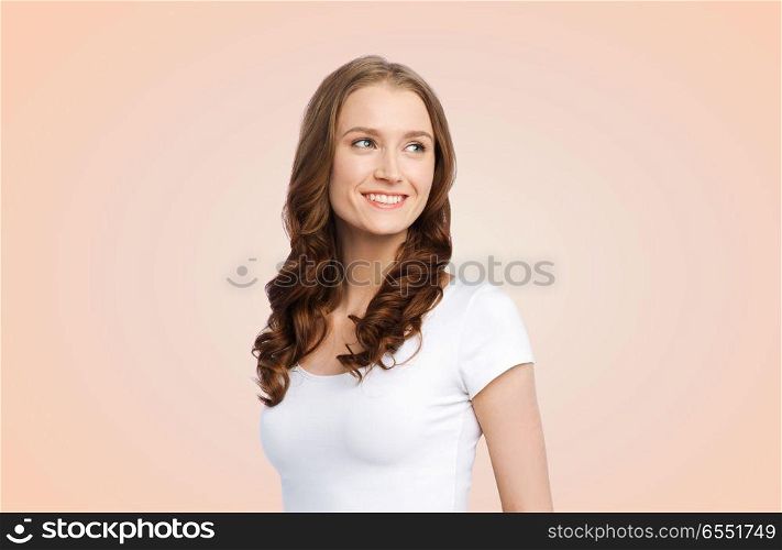 body positive and people concept - happy woman in white t-shirt over beige background. happy woman in white t-shirt. happy woman in white t-shirt