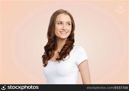 body positive and people concept - happy woman in white t-shirt over beige background. happy woman in white t-shirt. happy woman in white t-shirt