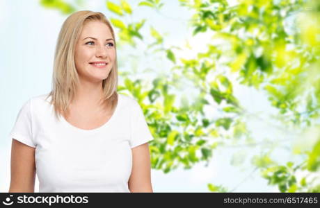 body positive and people concept - happy woman in white t-shirt over green natural background. happy woman in white t-shirt. happy woman in white t-shirt