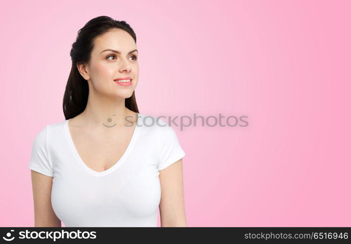 body positive and people concept - happy woman in white t-shirt over pink background. happy woman in white t-shirt over pink background. happy woman in white t-shirt over pink background