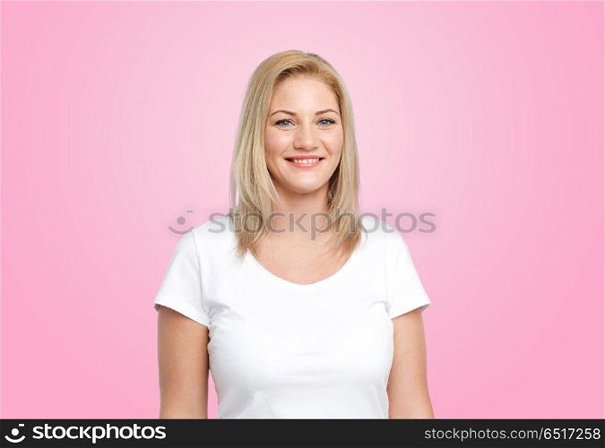body positive and people concept - happy woman in white t-shirt over pink background. happy woman in white t-shirt over pink background. happy woman in white t-shirt over pink background