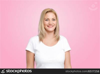 body positive and people concept - happy woman in white t-shirt over pink background. happy woman in white t-shirt over pink background. happy woman in white t-shirt over pink background