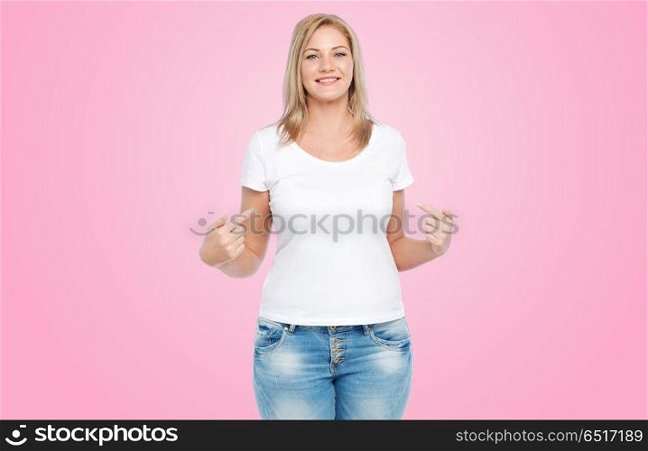 body positive, plus size and people concept - happy woman in white t-shirt pointing fingers to herself over pink background. woman in white t-shirt pointing fingers to herself. woman in white t-shirt pointing fingers to herself
