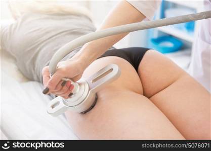 Body treatment: woman getting rf lifting procedure to her buttocks. rf lifting procedure