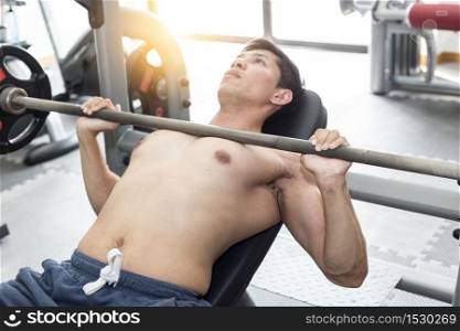 Bodybuilder Men workout with barbell in gym focus on muscle so strong and powerful
