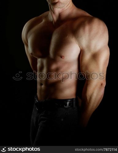 bodybuilder posing. Handsome power athletic guy male. Fitness muscular body on black background.