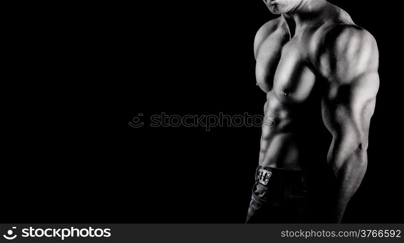 Bodybuilder showing his muscles. on a black background