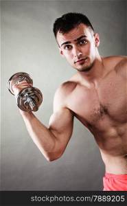 Bodybuilding. Strong fit man exercising with dumbbells. Closeup muscular young guy lifting weights dark background