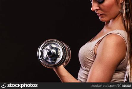 Bodybuilding. Strong fit woman exercising with dumbbells. Closeup muscular girl lifting weights on black