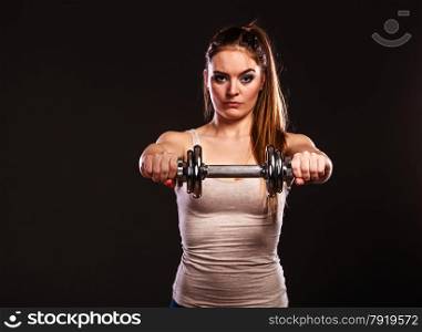 Bodybuilding. Strong fit woman exercising with dumbbells. muscular girl lifting weights on black