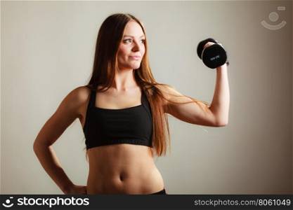 Bodybuilding. Strong fit woman exercising with dumbbells. Muscular long hair girl lifting weights