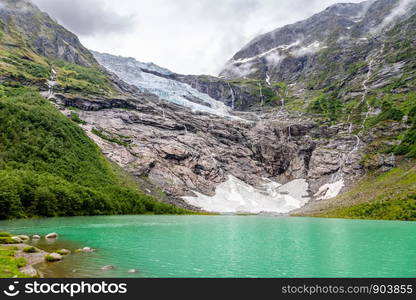 Boeyabreen Glacier in the mountains with lake in the foreground, Jostedalsbreen National Park, Fjaerland, Norway