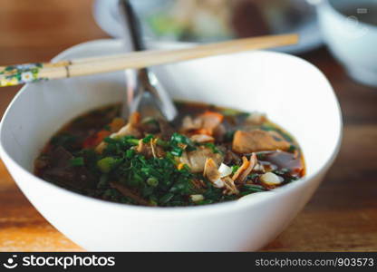 Boil pork blood, Thai food, placed on a wooden table, blurred scenes