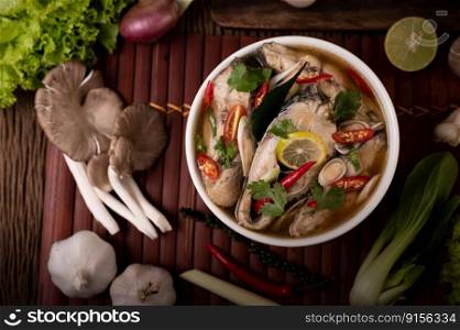 Boil the fish infusion with tomatoes, mushrooms, coriander, spring onion and lemongrass in a bowl.