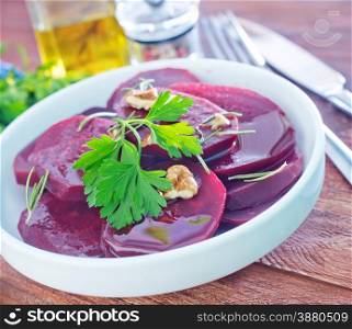 boiled beet with oil in the white plate