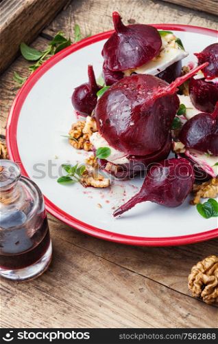 Boiled beetroot with soft cheese and walnut. Appetizer of beetroot with cheese