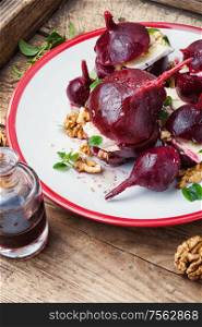 Boiled beetroot with soft cheese and walnut. Appetizer of beetroot with cheese