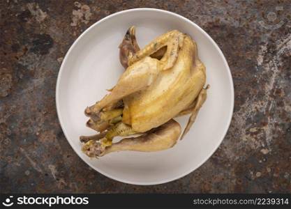 boiled chicken in simply ceramic plate on rusty texture background, top view, flat lay