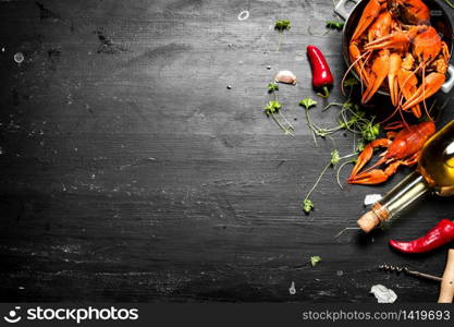 Boiled crawfish with white wine and spices. On a black chalkboard.. Boiled crawfish with white wine and spices.