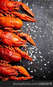 Boiled crayfish with parsley. On a black background. High quality photo. Boiled crayfish with parsley. On a black background.