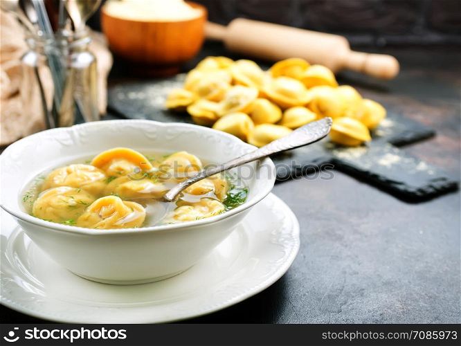 Boiled dumplings in bowl and on a table