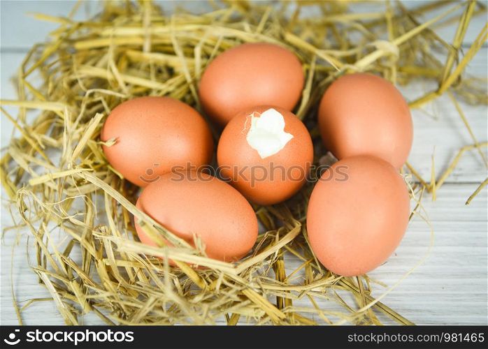 boiled egg and fresh eggs on straw background / Soft boiled eggs