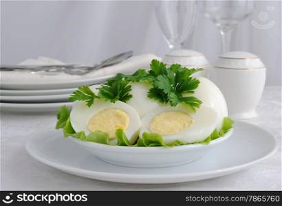 Boiled eggs in a cut with parsley on a plate