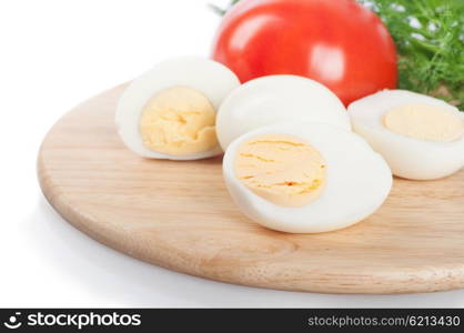 Boiled hen eggs and tomato on a white background
