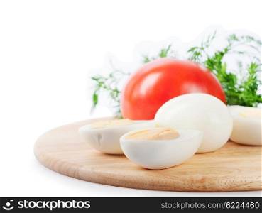 Boiled hen eggs and tomato on a white background