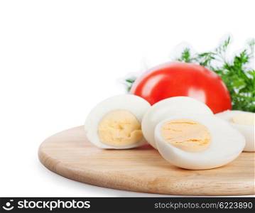 Boiled hen eggs, green dill and tomato on a white background