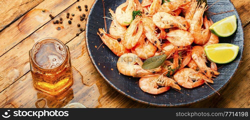 Boiled large shrimp and beer in jars.Fresh cooked prawns,seafood. Boiled shrimp and light beer