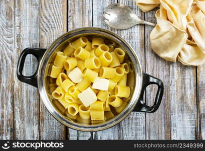 boiled pasta with butter in metal bowl