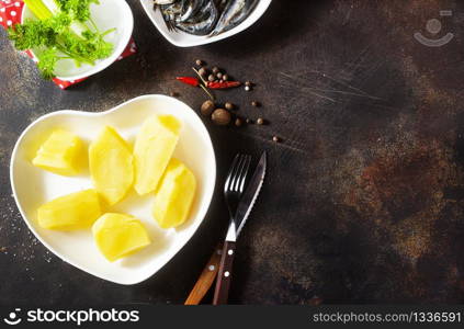 boiled peeled potatoes with bay leaves and fish