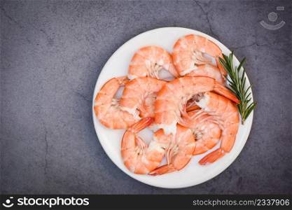 boiled peeled shrimp prawns cooked in the seafood restaurant, Fresh shrimps served on white plate with rosemary