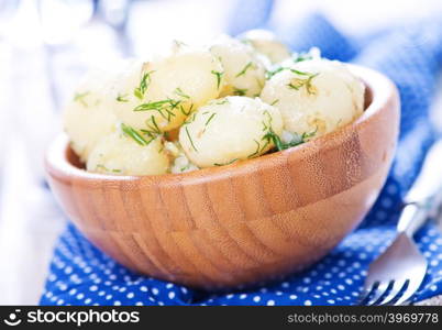 boiled potato in bowl and on a table