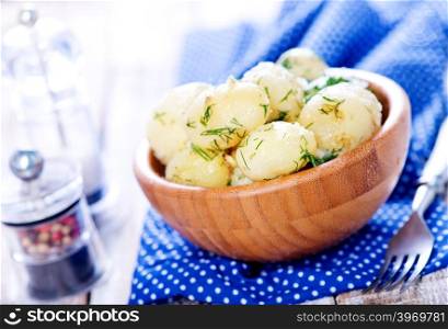 boiled potato in bowl and on a table