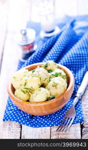 boiled potato in bowl and on a table