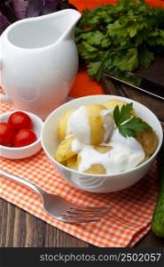 Boiled potatoes with parsley and sour cream