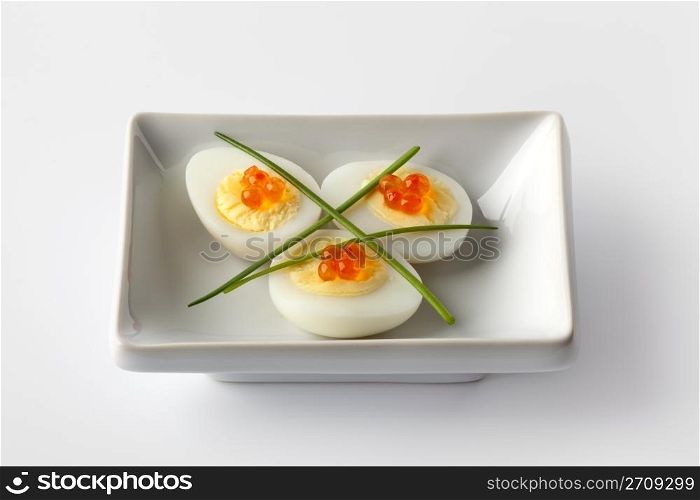 Boiled quail eggs with trout eggs and chive