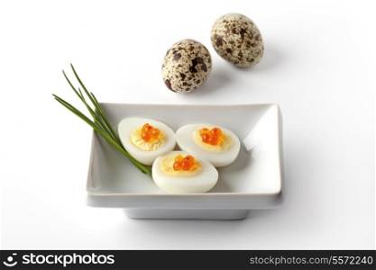 Boiled quail eggs with trout eggs and chive