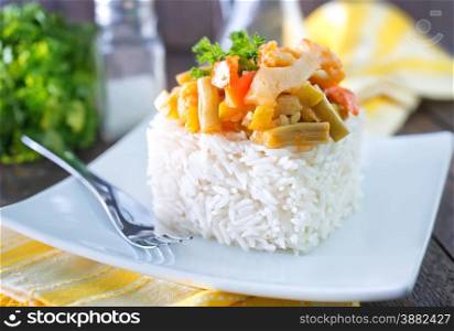 boiled rice and vegetables on the white plate