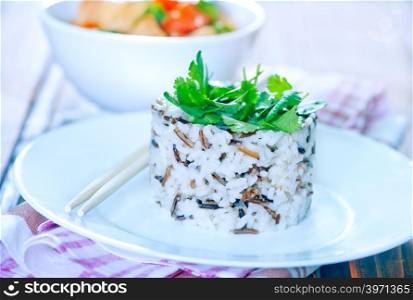 boiled rice on plate and on a table