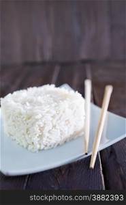 boiled rice on white plate and on a table