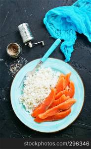 boiled rice with salmon on plate, diet food