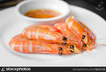 Boiled shrimps on plate served with spicy sauce