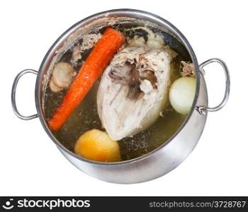 boiling of chicken broth with seasoning vegetables in steel pan isolated on white background